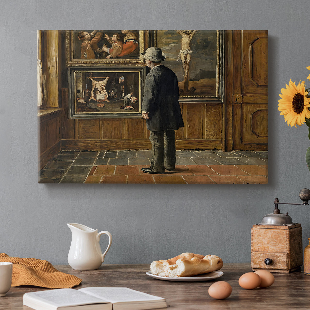 Canvas art print featuring a figure standing indoors closely examining framed artwork on wall, set in a cozy kitchen setting
