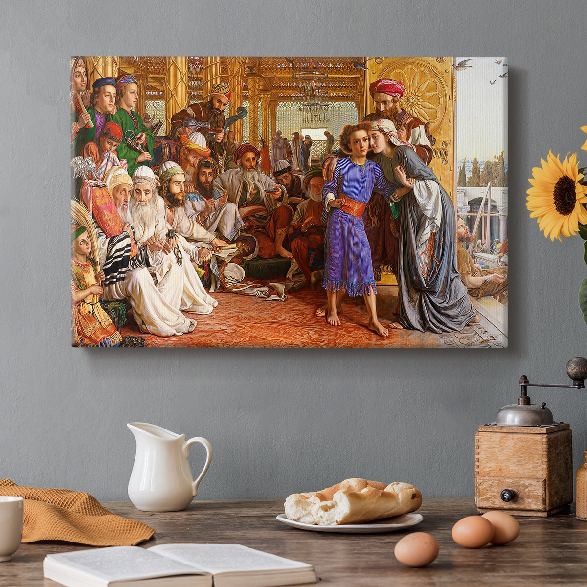 Canvas art print featuring a crowded temple scene with figures in robes surrounding central figure, set in a cozy kitchen setting