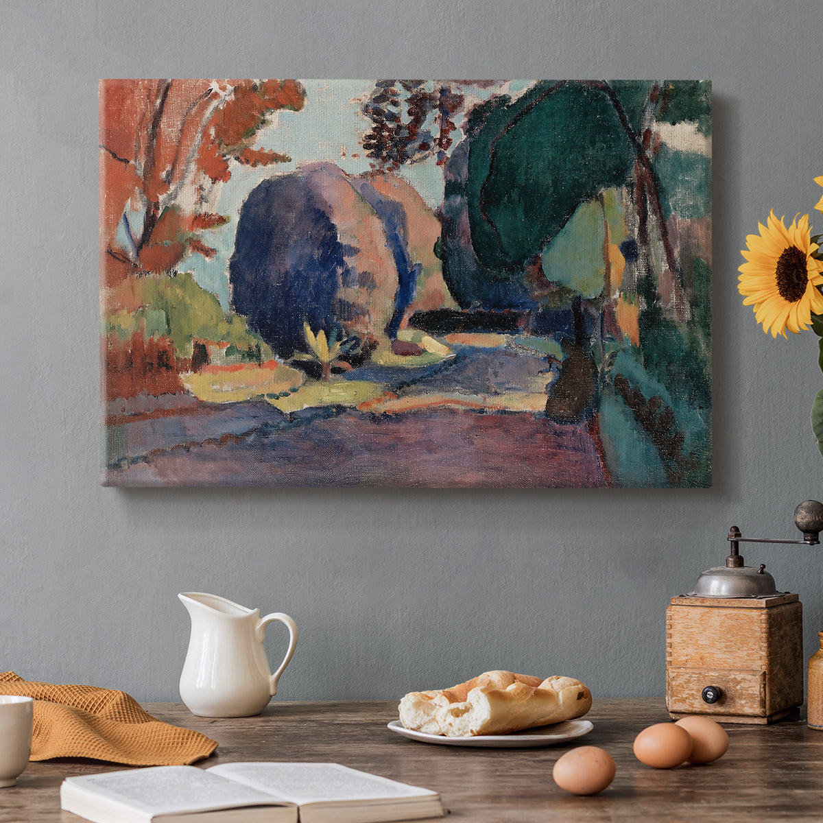 Canvas art print featuring a garden landscape with figure and dense greenery, set in a cozy kitchen setting