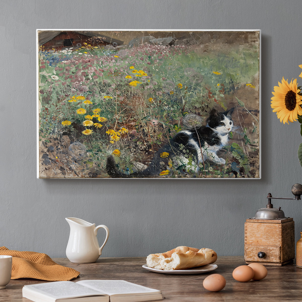 Canvas art print featuring a cat crouching in a meadow filled with wildflowers and greenery, set in a cozy kitchen setting