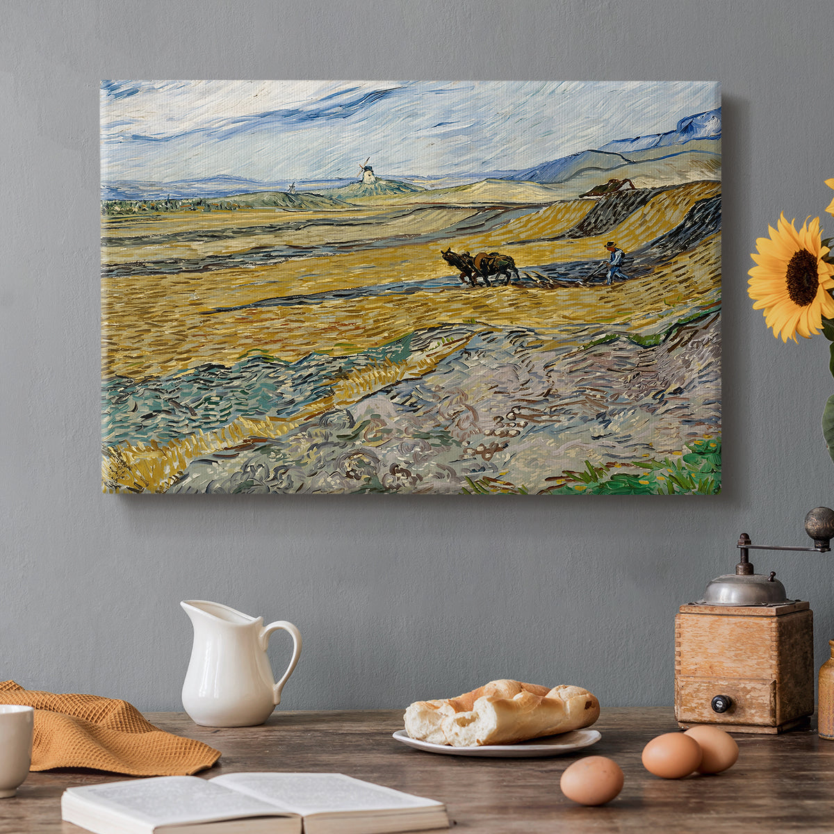 Canvas art print featuring a ploughed field enclosed by low walls with lone worker under broad sky, set in a cozy kitchen setting
