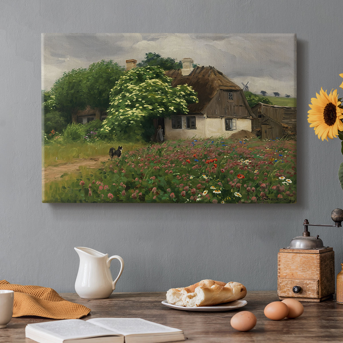 Canvas art print featuring a farmhouse surrounded by meadow filled with wildflowers and greenery, set in a cozy kitchen setting