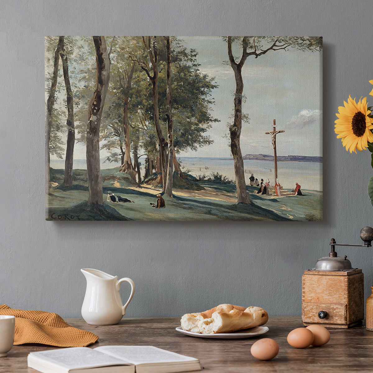 Canvas art print featuring a hillside landscape with religious cross overlooking trees and distant terrain, set in a cozy kitchen setting