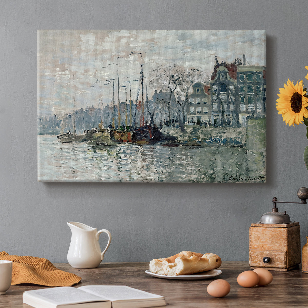 Canvas art print featuring a canal scene with boats and buildings lining waterfront in Amsterdam, set in a cozy kitchen setting