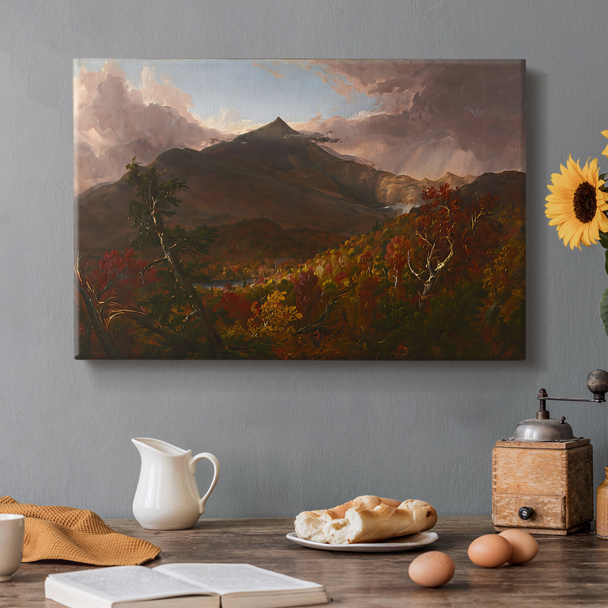 Canvas art print featuring a mountain landscape clearing after storm with sunlight breaking through clouds, set in a cozy kitchen setting