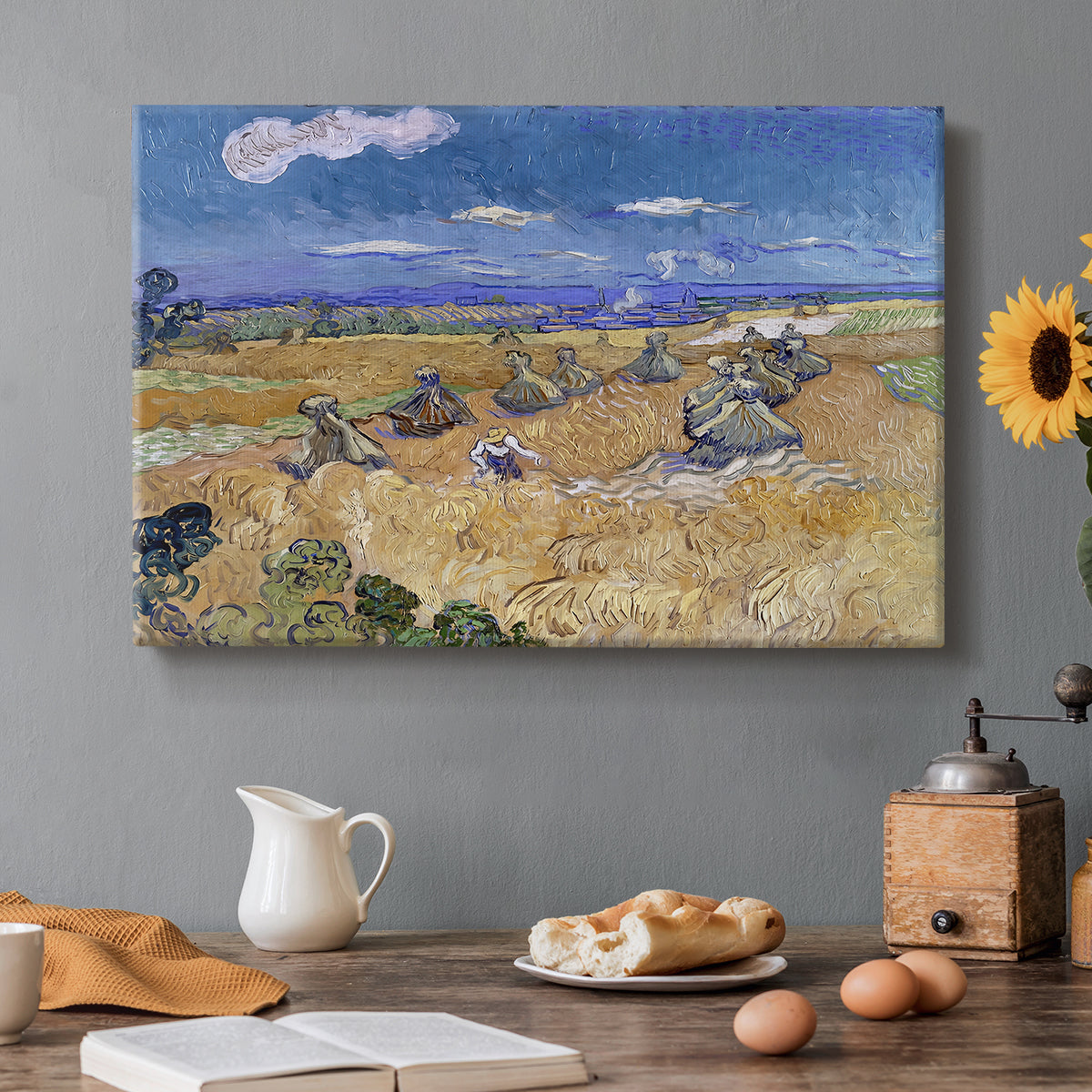 Canvas art print featuring a figure harvesting wheat in expansive field under bright sky, set in a cozy kitchen setting
