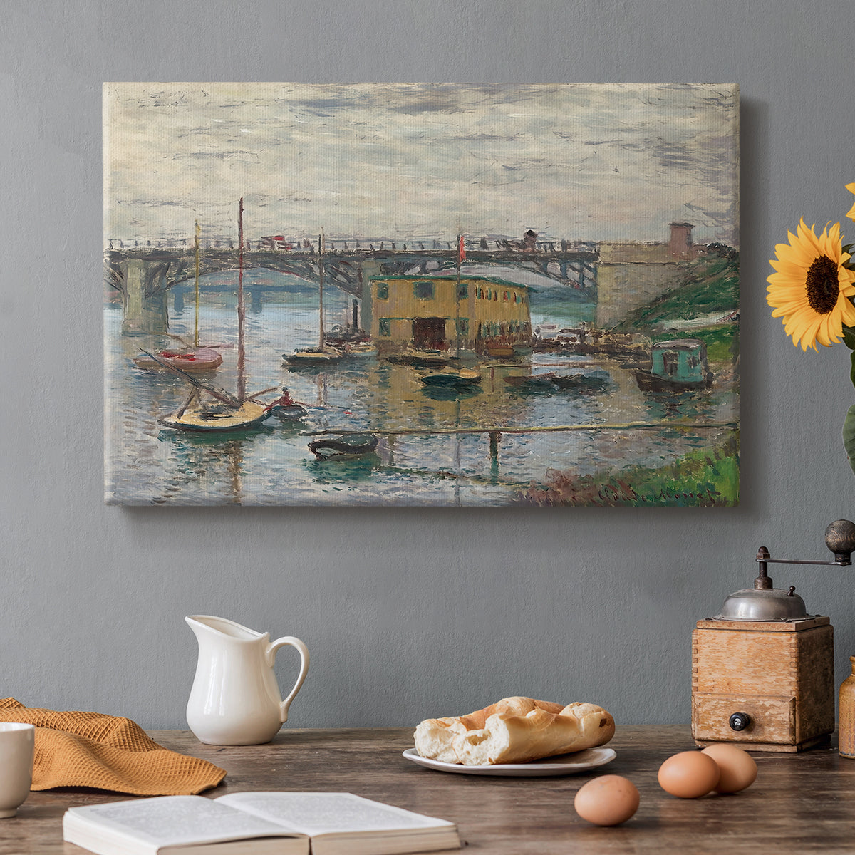 Canvas art print featuring a bridge crossing river under gray sky with muted reflections, set in a cozy kitchen setting