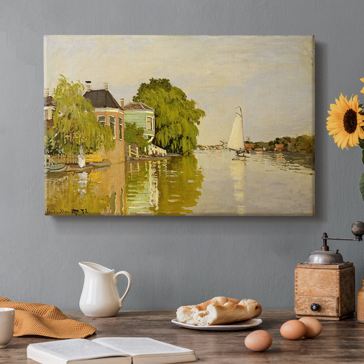Canvas art print featuring colorful houses reflected in calm river surrounded by greenery, set in a cozy kitchen setting