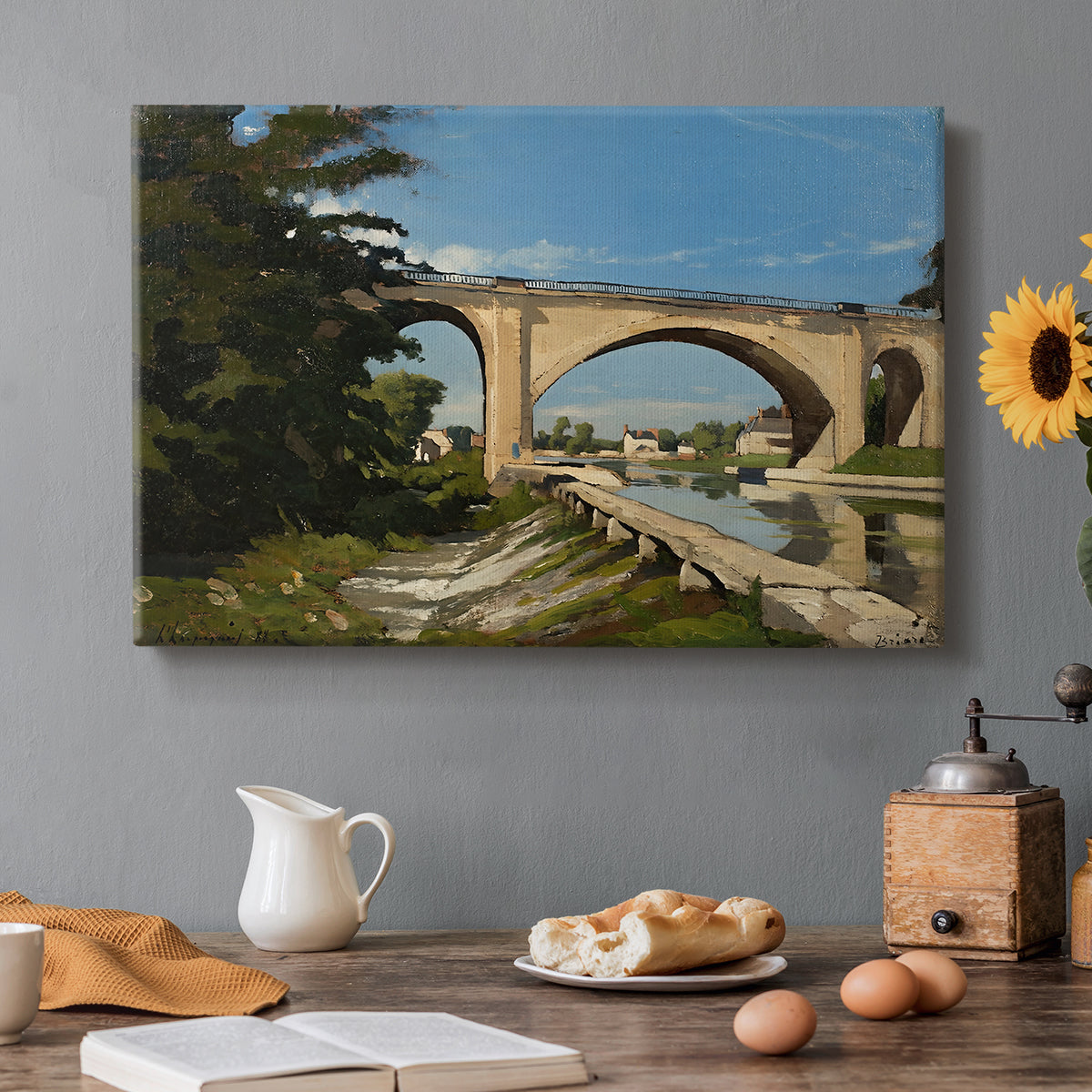 Canvas art print featuring an arched bridge spanning river with structure reflected in water, set in a cozy kitchen setting