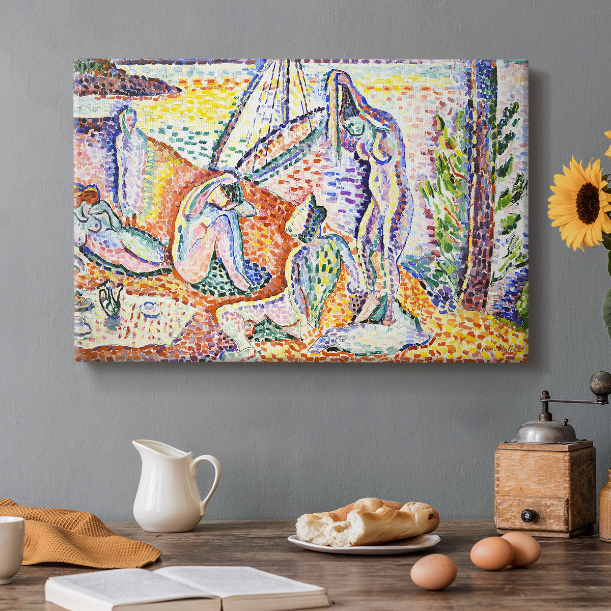 Canvas art print featuring figures relaxing in a bright coastal landscape with water and trees, set in a cozy kitchen setting