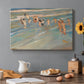 Canvas art print featuring children playing along shoreline with waves and wet sand, set in a cozy kitchen setting