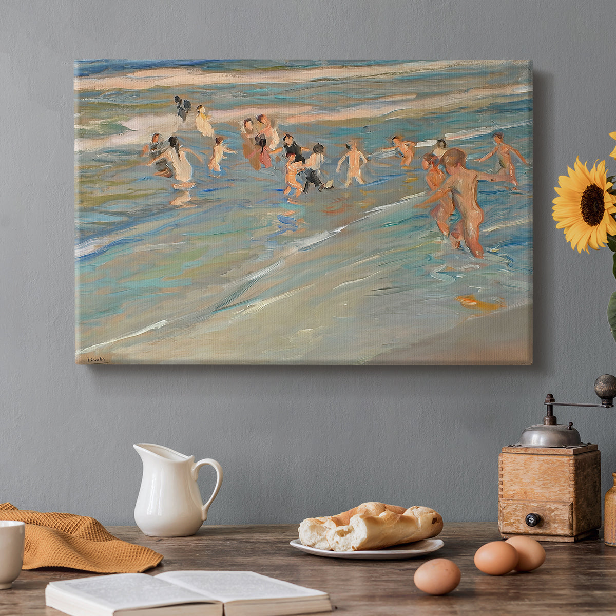 Canvas art print featuring children playing along shoreline with waves and wet sand, set in a cozy kitchen setting