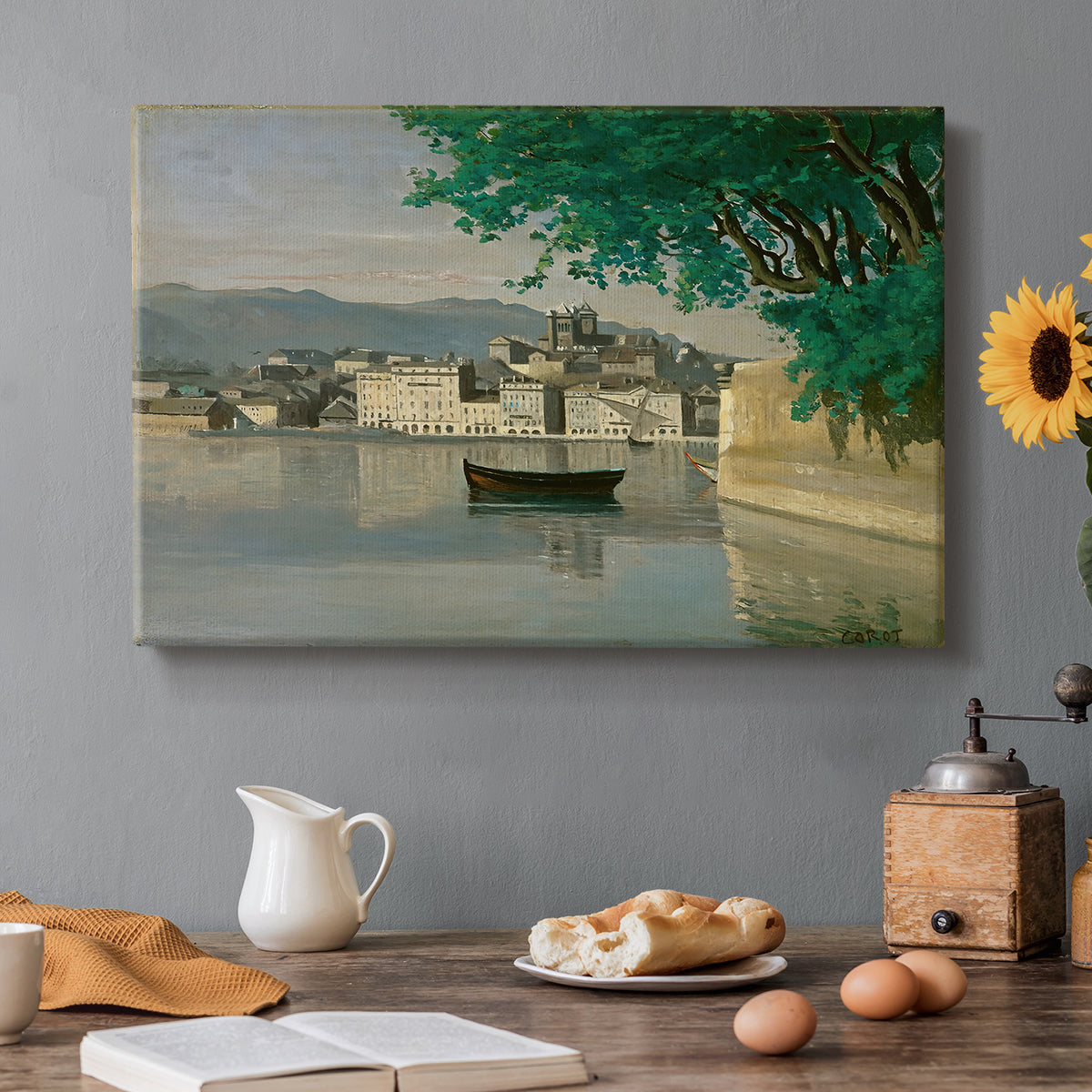 Canvas art print featuring a waterfront city view with buildings and boats along calm water, set in a cozy kitchen setting