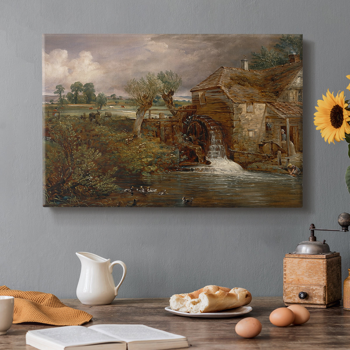 Canvas art print featuring a mill beside water in rural setting, set in a cozy kitchen setting