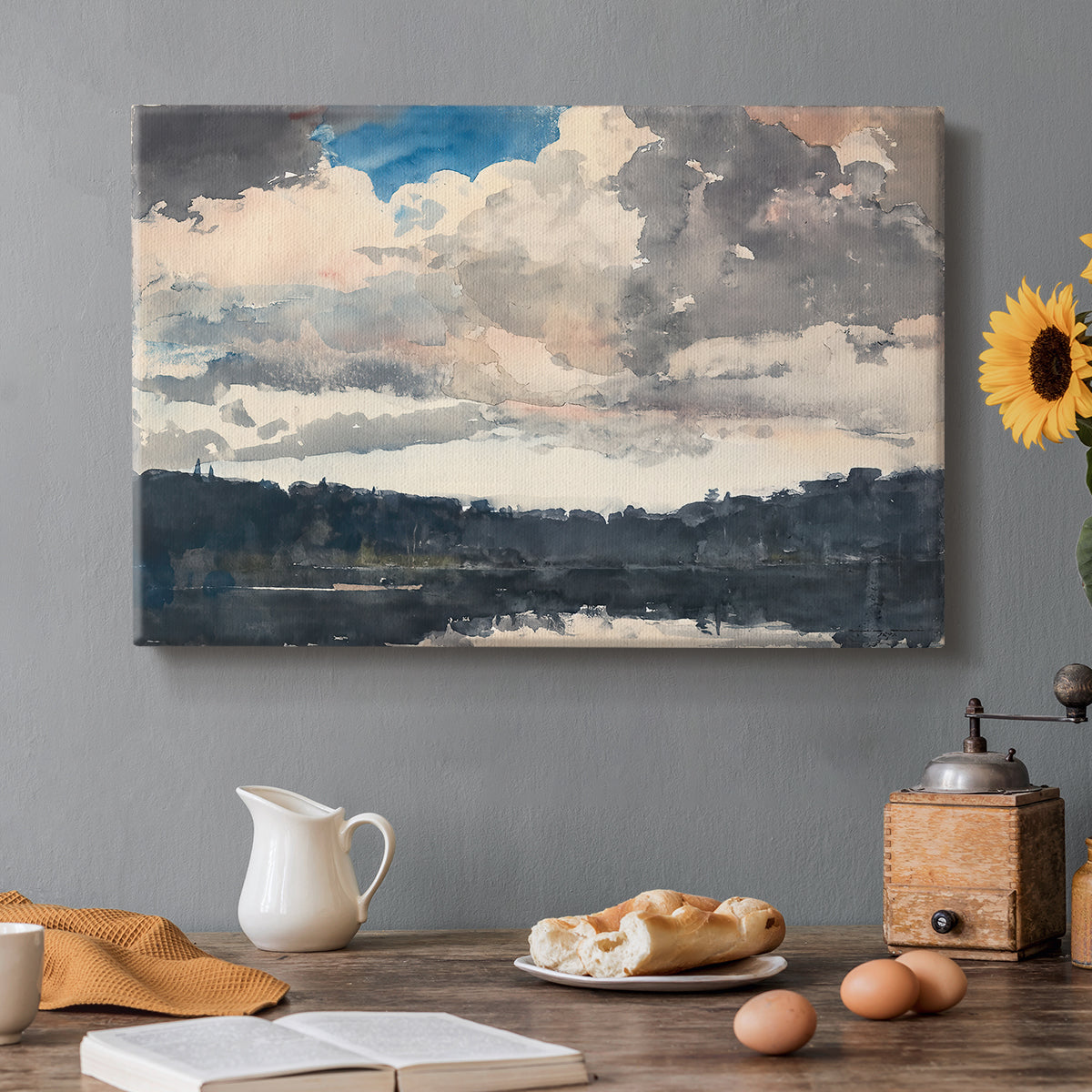 Canvas art print featuring a single boat floating on still lake surrounded by forested shoreline, set in a cozy kitchen setting