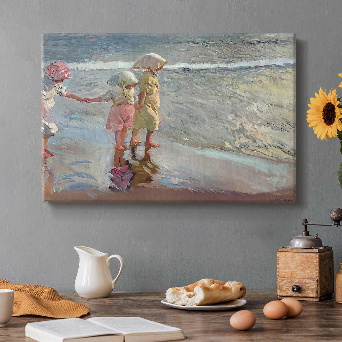 Canvas art print featuring three women standing together on beach in flowing dresses, set in a cozy kitchen setting
