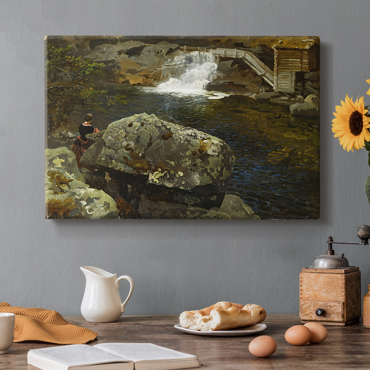 Canvas art print featuring a small pond beside mill surrounded by trees and greenery, set in a cozy kitchen setting
