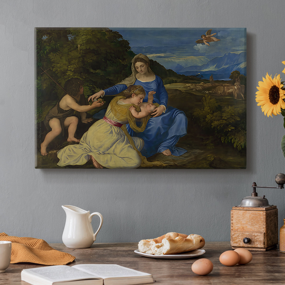 Canvas art print featuring Madonna seated with child in landscape beside soft blue water and sky, set in a cozy kitchen setting