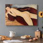 Canvas art print featuring a nude woman reclining on her stomach viewed from behind with elongated back, set in a cozy kitchen setting