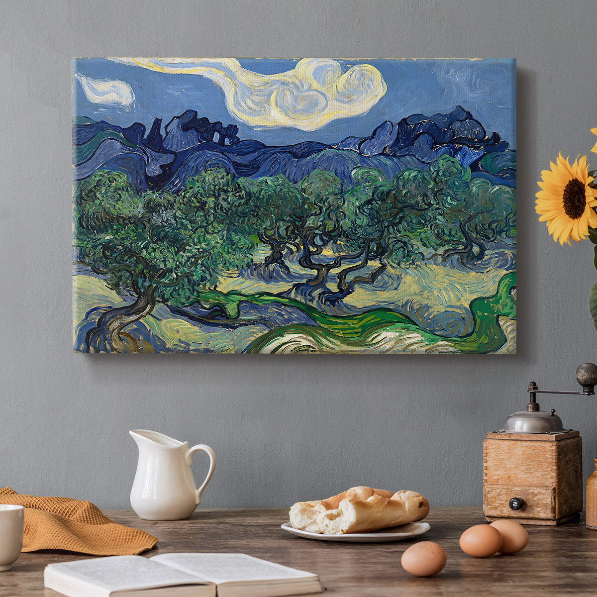 Canvas art print featuring an olive grove with twisted trees set before distant mountain range, set in a cozy kitchen setting