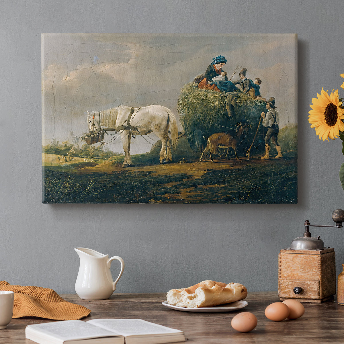 Canvas art print featuring a wagon carrying hay through countryside, set in a cozy kitchen setting