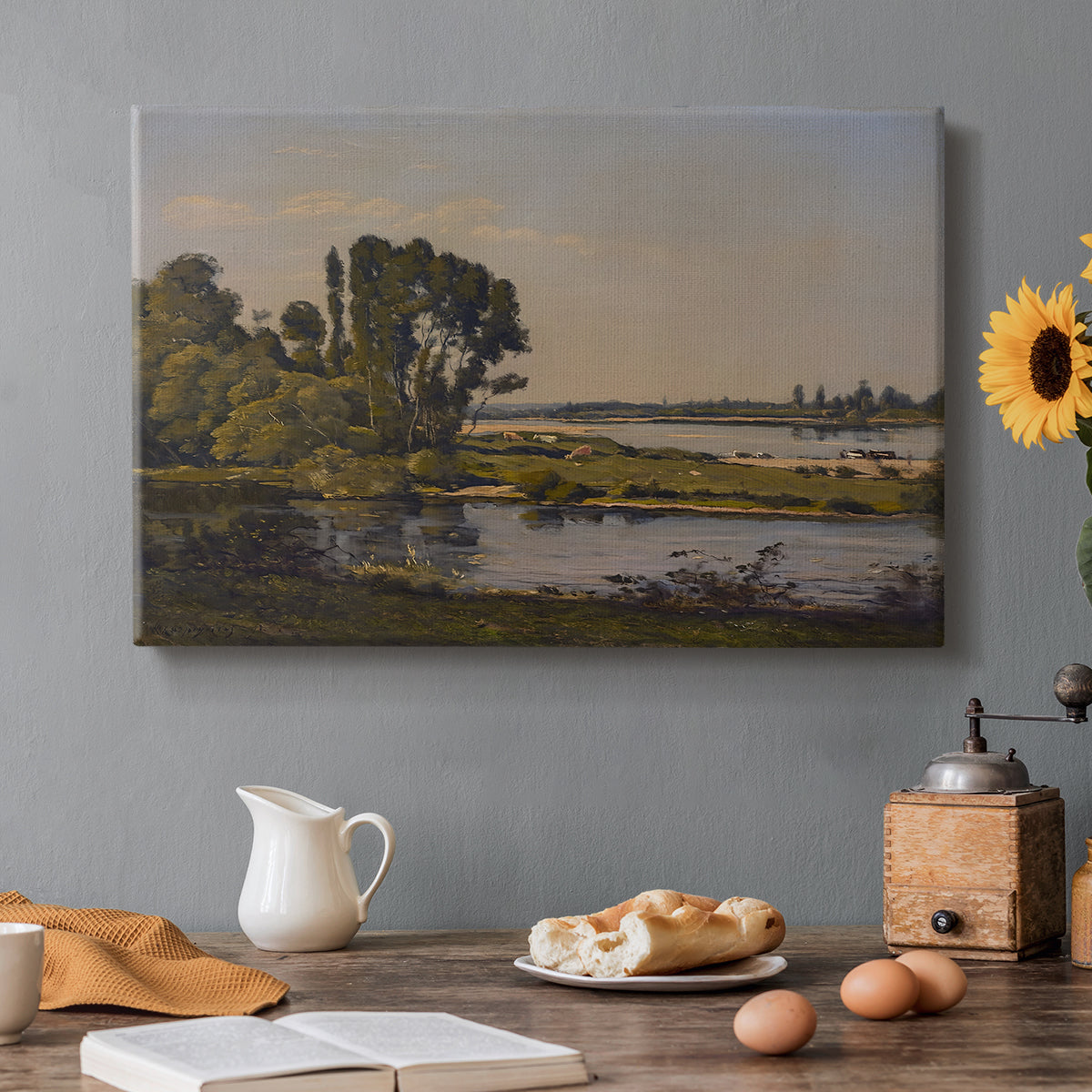 Canvas art print featuring a calm river winding through countryside with trees and open sky, set in a cozy kitchen setting