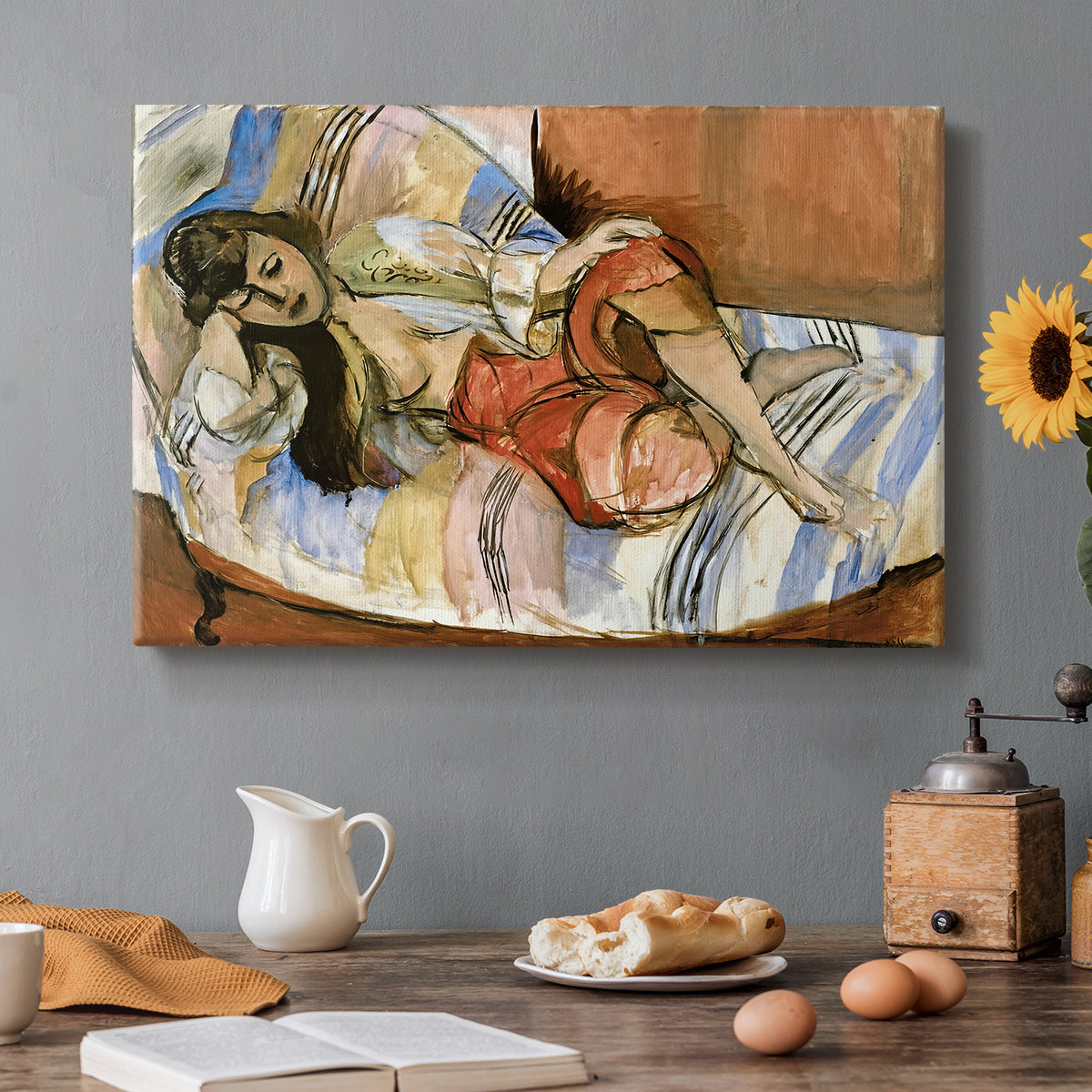 Canvas art print featuring a reclining woman resting on patterned textiles in a decorative interior, set in a cozy kitchen setting