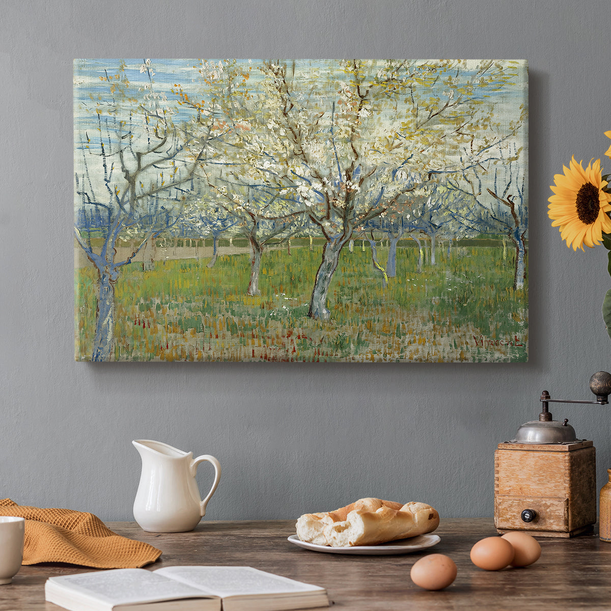 Canvas art print featuring an orchard in bloom with pink blossoms across soft landscape, set in a cozy kitchen setting