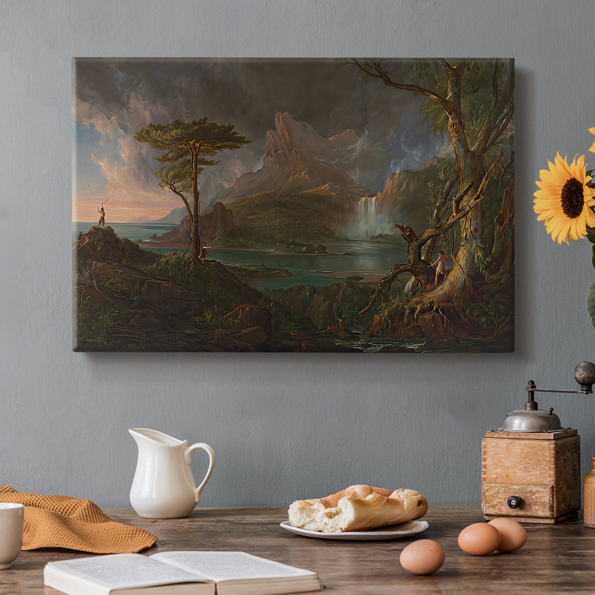 Canvas art print featuring a rugged natural landscape with dense trees and flowing water under dramatic sky, set in a cozy kitchen setting