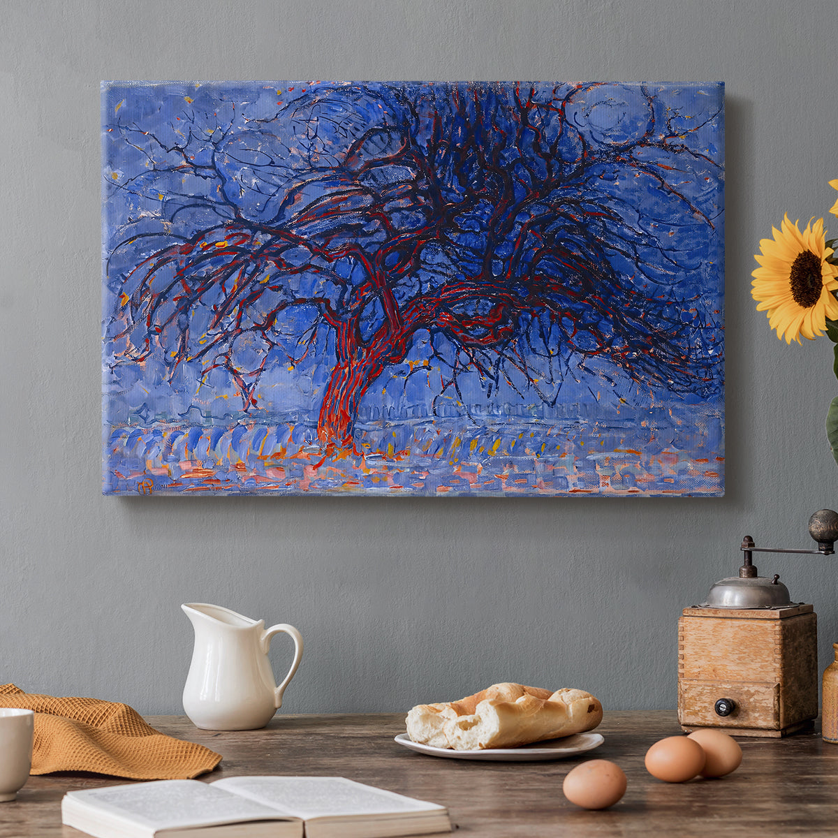 Canvas art print featuring a stylized red tree with branches against dark background, set in a cozy kitchen setting