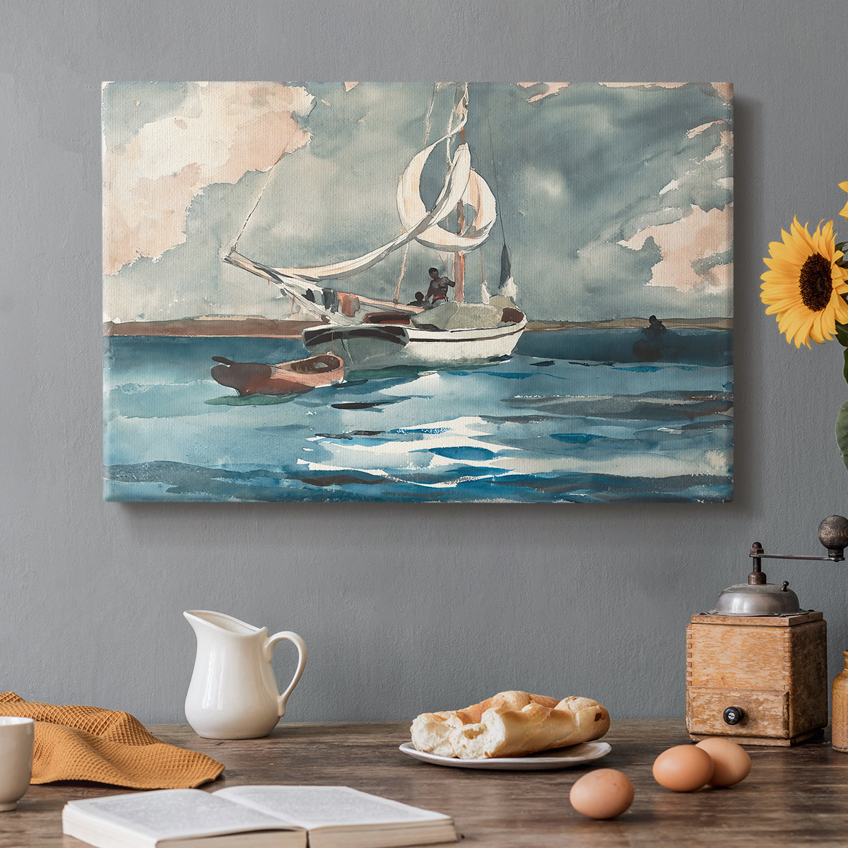 Canvas art print featuring a single sailboat moving across bright blue water under clear sky, set in a cozy kitchen setting