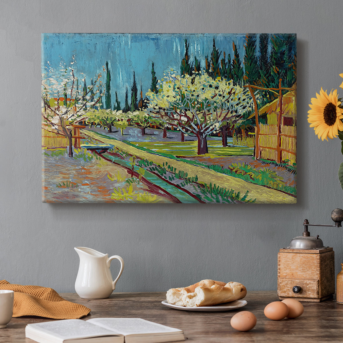 Canvas art print featuring rows of flowering trees enclosed by tall cypress trees in orchard setting, set in a cozy kitchen setting