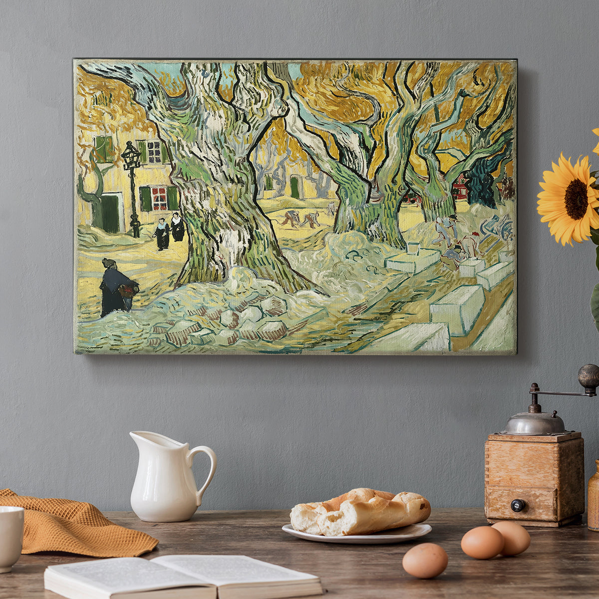 Canvas art print featuring a road lined with large trees where workers are gathered along path, set in a cozy kitchen setting