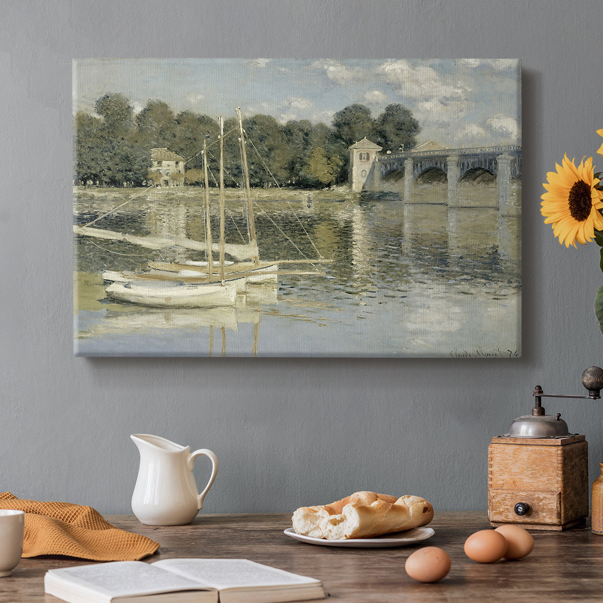 Canvas art print featuring a bridge spanning river with sailboats and reflections in water, set in a cozy kitchen setting