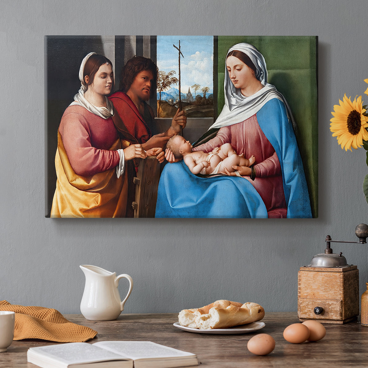 Canvas art print featuring a group of figures seated together in calm religious setting with soft landscape background, set in a cozy kitchen setting