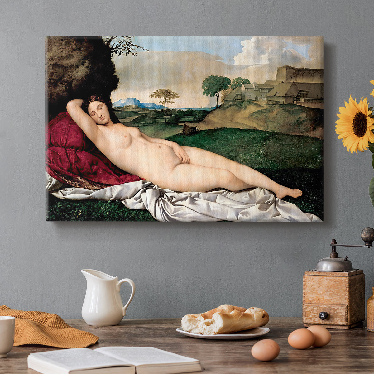 Canvas art print featuring a nude woman reclining asleep in open landscape with soft hills behind, set in a cozy kitchen setting