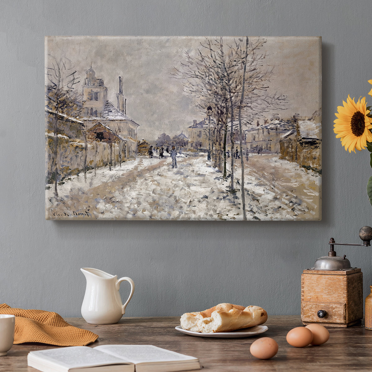 Canvas art print featuring a snow-covered street lined with trees and buildings under winter sky, set in a cozy kitchen setting
