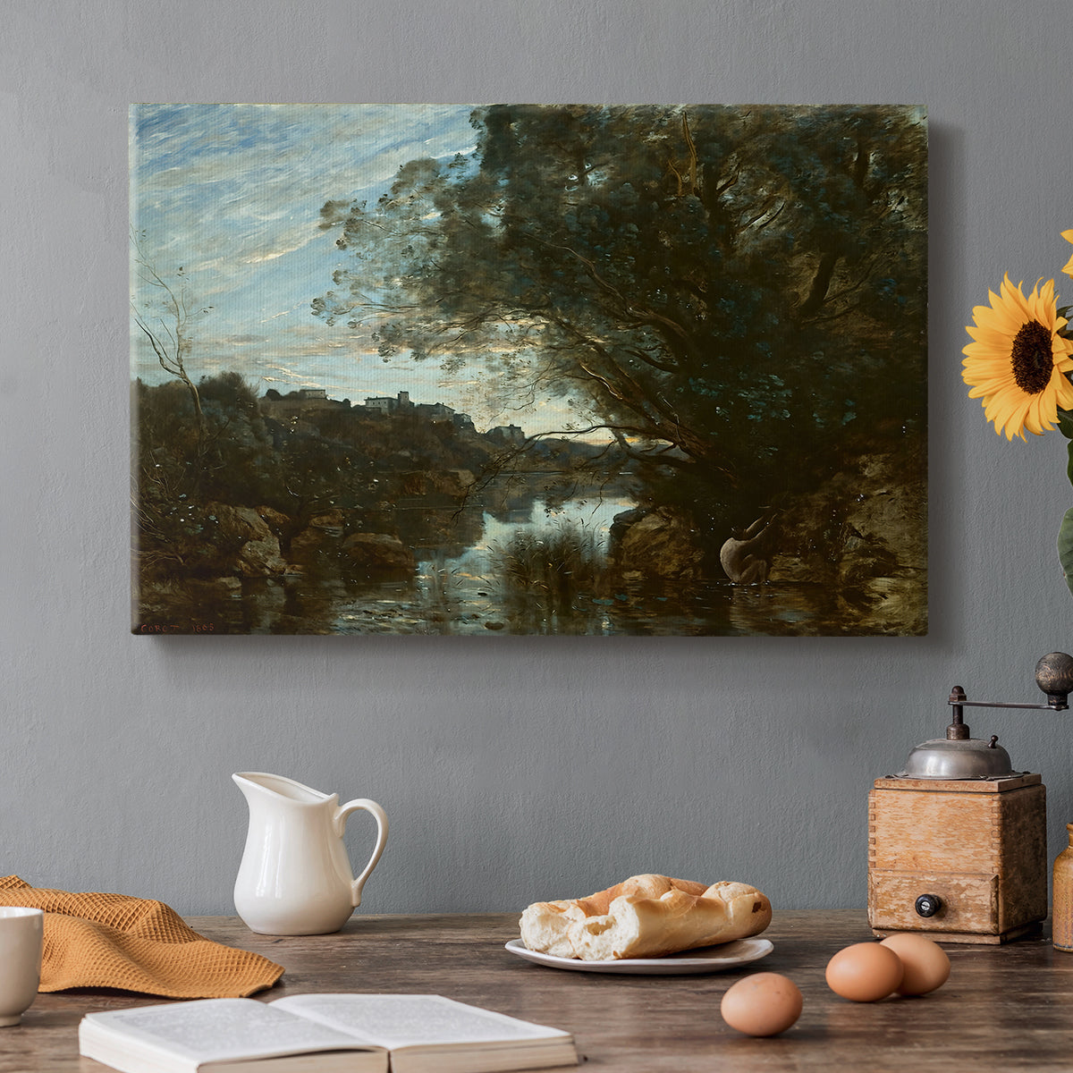 Canvas art print featuring a lake landscape surrounded by trees and distant hills under soft sky, set in a cozy kitchen setting