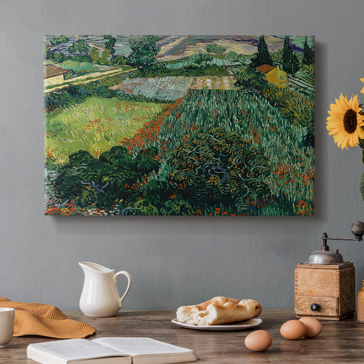 Canvas art print featuring a field dotted with red poppies under bright sky and rolling terrain, set in a cozy kitchen setting