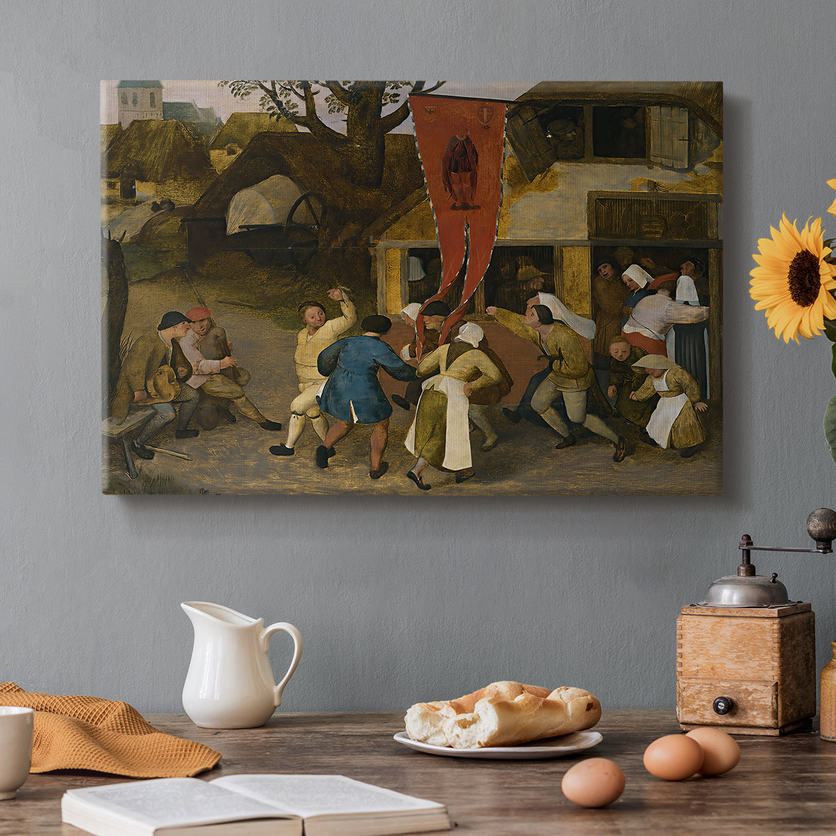 Canvas art print featuring villagers gathered outdoors celebrating in festive scene, set in a cozy kitchen setting