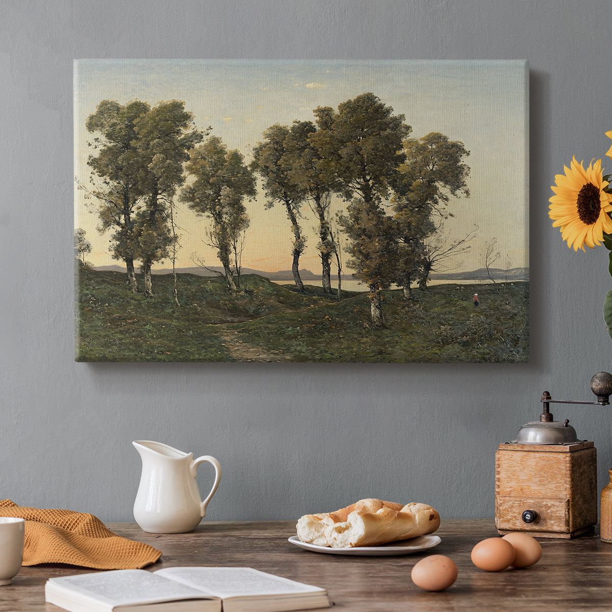 Canvas art print featuring trees silhouetted against evening sky in warm autumn tones, set in a cozy kitchen setting