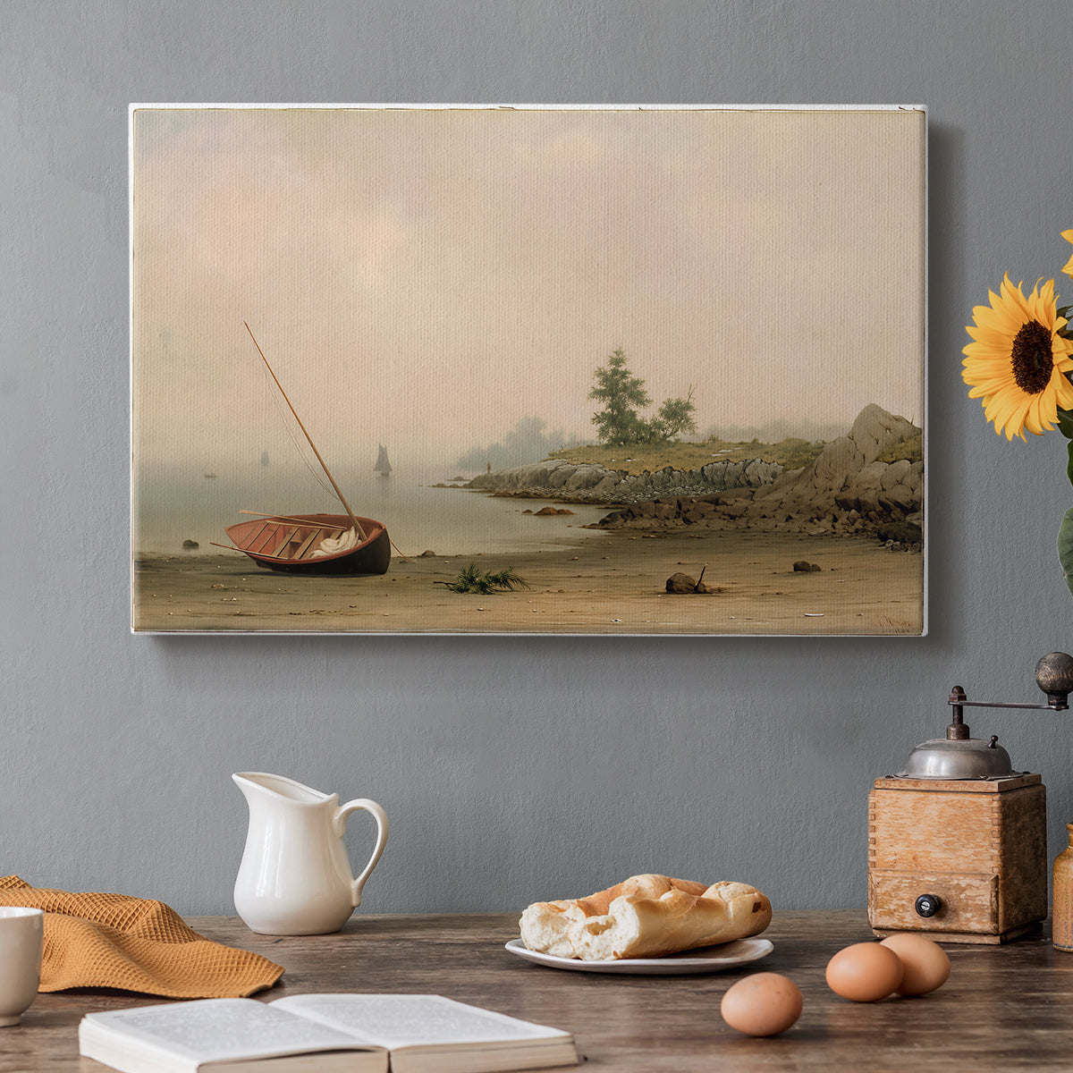 Canvas art print featuring a small boat resting on shoreline beside calm water and open sky, set in a cozy kitchen setting