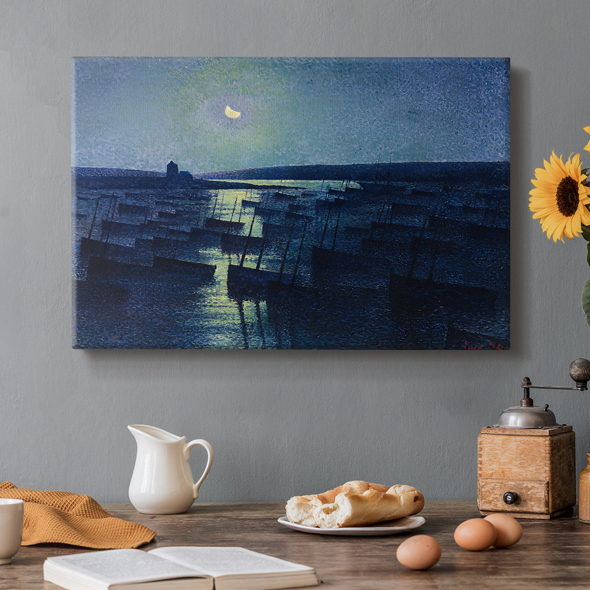 Canvas art print featuring fishing boats resting in harbor under moonlit sky, set in a cozy kitchen setting