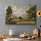 Canvas art print featuring a country house surrounded by trees in landscaped grounds, set in a cozy kitchen setting