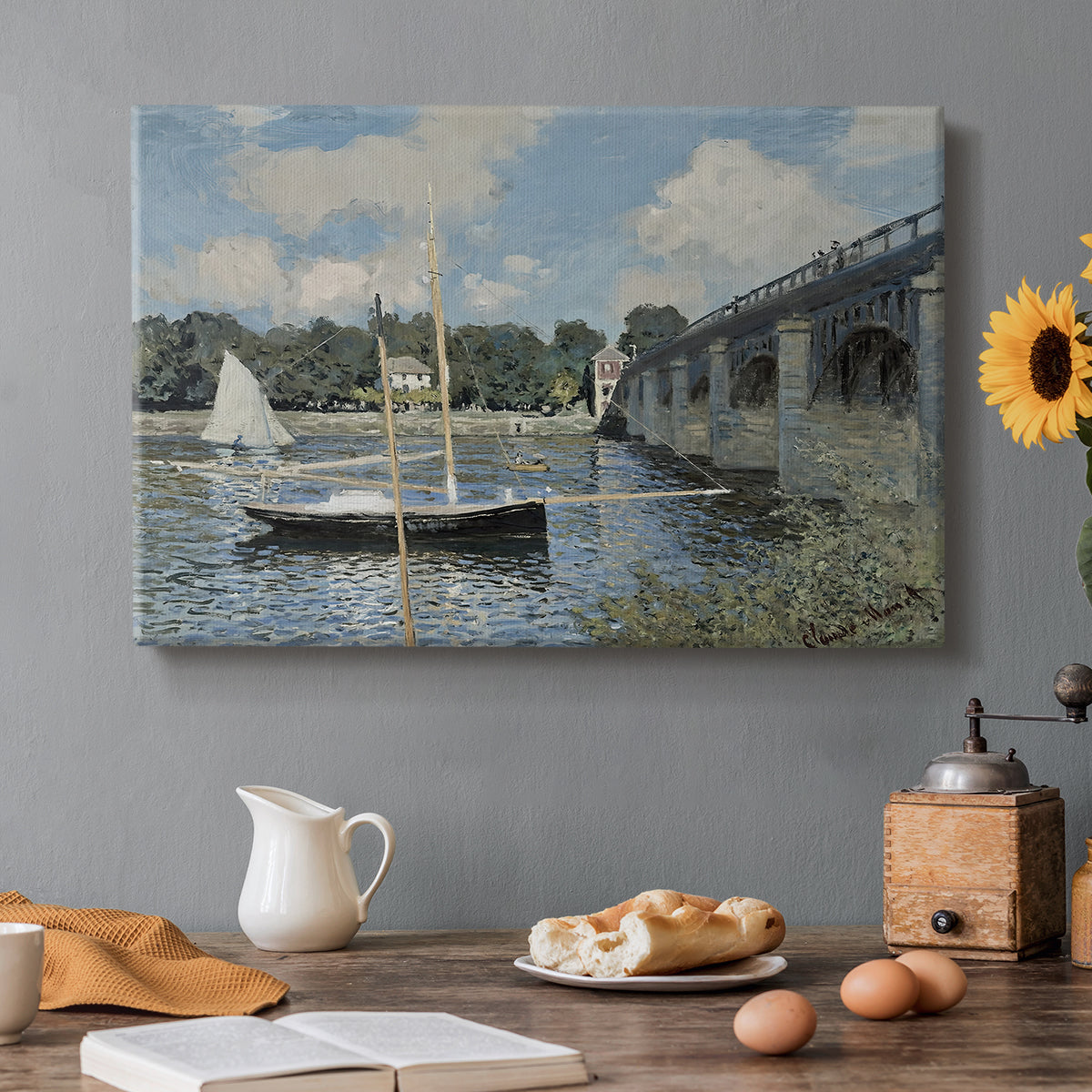 Canvas art print featuring a bridge spanning river with sailboats and reflections in bright daylight, set in a cozy kitchen setting