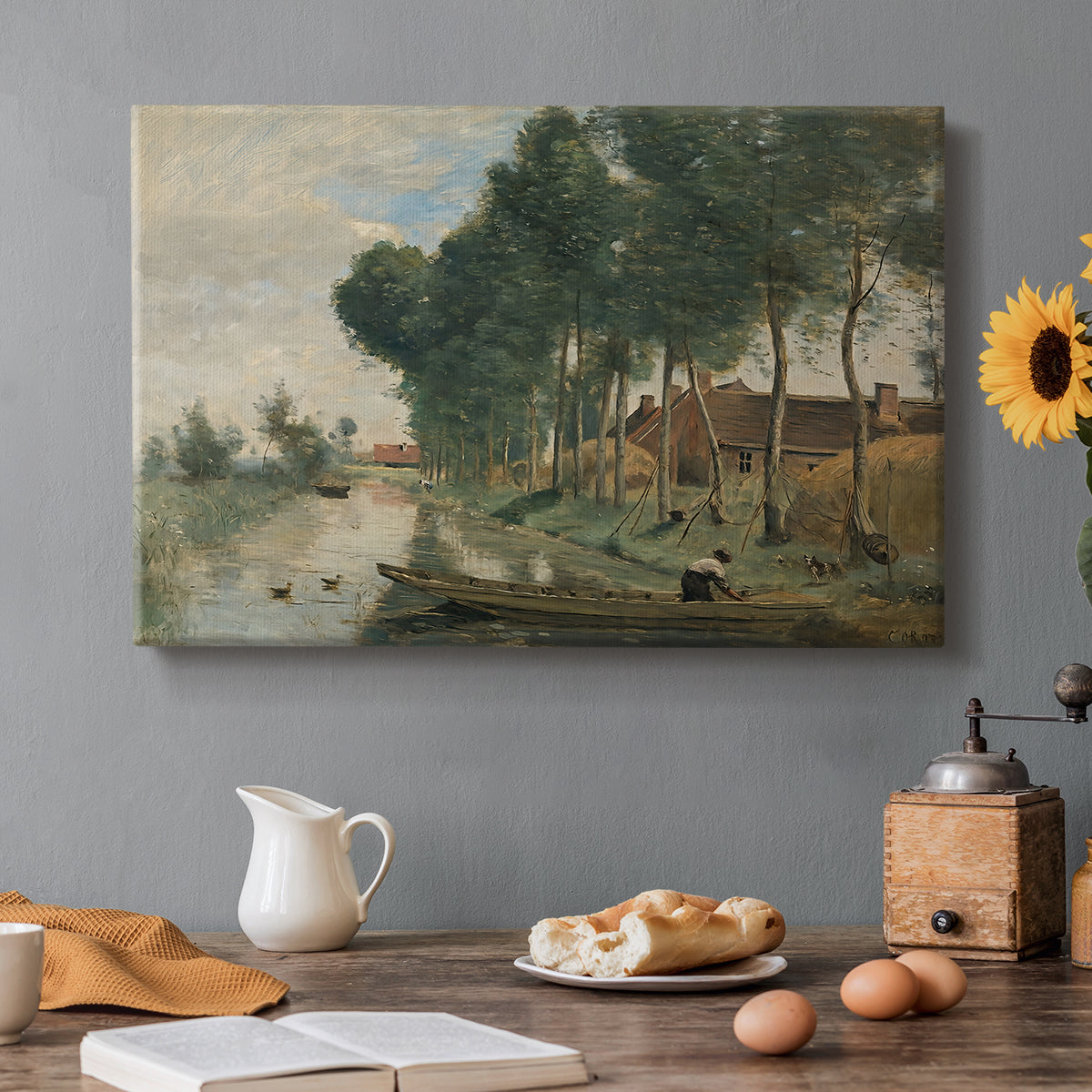 Canvas art print featuring a quiet rural landscape with trees and open terrain under muted sky, set in a cozy kitchen setting