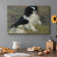 Canvas art print featuring a small black and white dog standing in shallow water with soft brushstrokes, set in a cozy kitchen setting