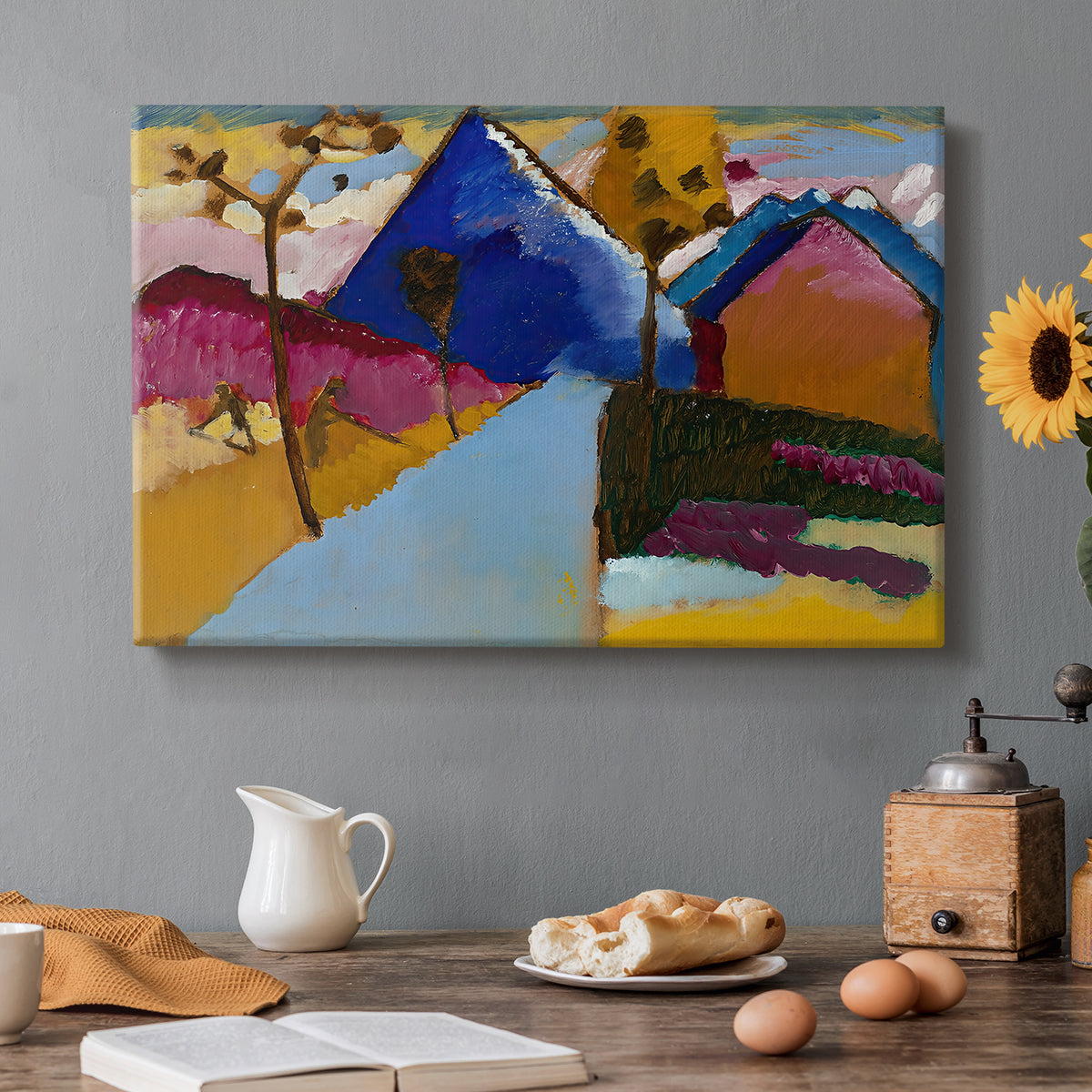 Canvas art print featuring a simplified street scene with buildings and landscape rendered in bold color blocks, set in a cozy kitchen setting