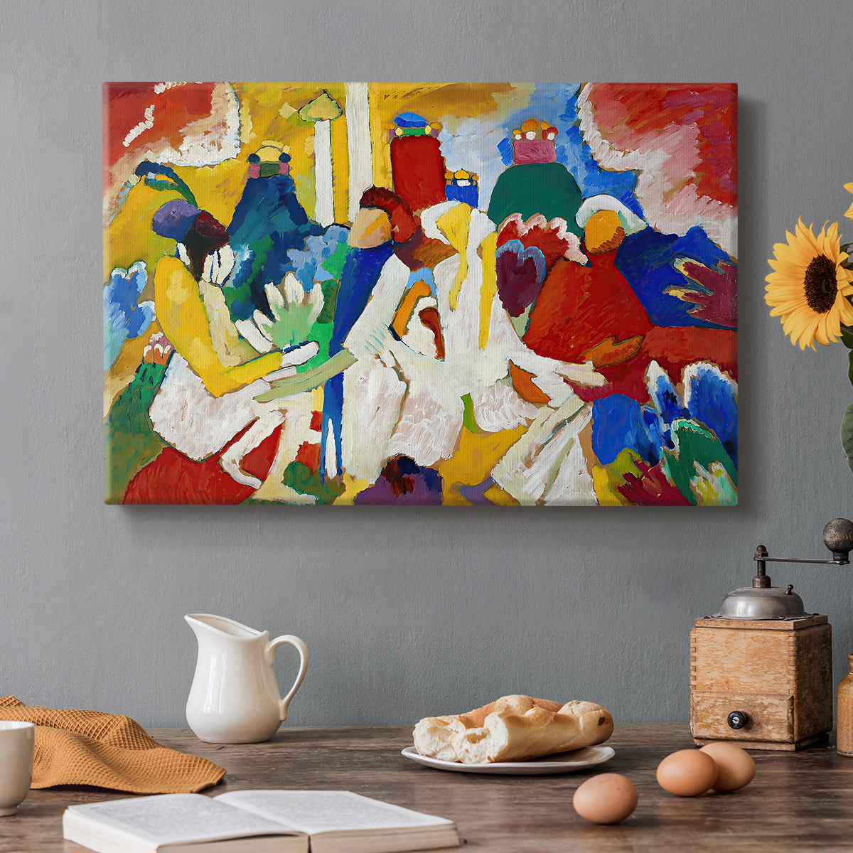 Canvas art print featuring a colorful abstract composition with clustered shapes suggesting figures and decorative elements, set in a cozy kitchen setting