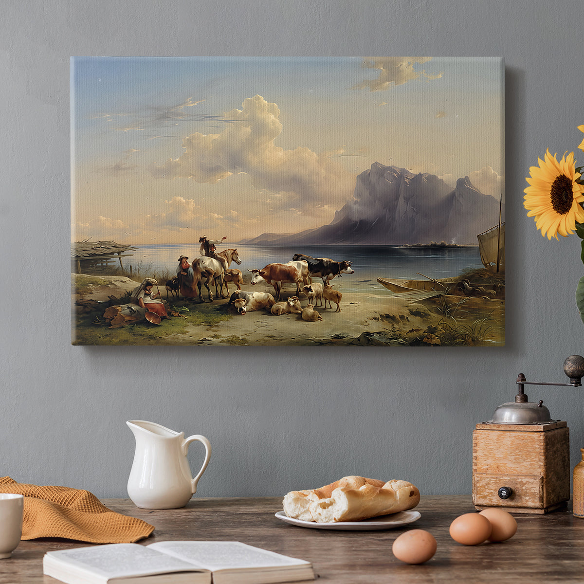 Canvas art print featuring shepherds tending cattle near lake with mountains, set in a cozy kitchen setting